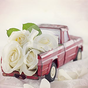 Red toy truck with white roses