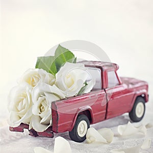 Red toy truck with white roses