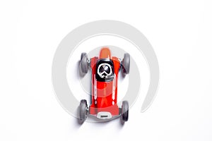 Red toy vintage racing car close up still isolated on a white background