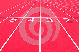 Red track and field lanes and numbers. Running lanes at a track and field athletic center. Horizontal sport theme poster, greeting