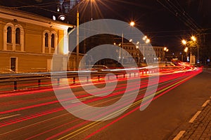 Red tracks from car headlamps on the bridge at night