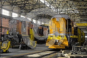 Red traction locomotives on serviced at a repair depot