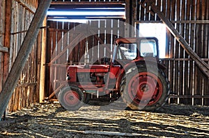 Red tractor in barn