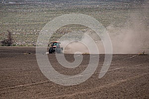 Red Tractor with Blowing Dust