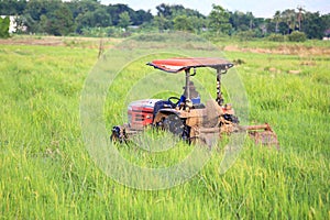 Red tractor in green field