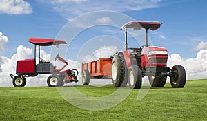 Red tractor and mowers with trailer