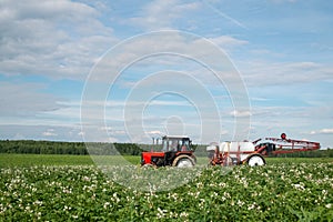 Red tractor sprayer in the field