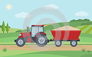 Red tractor with trailer on rural landscape background.
