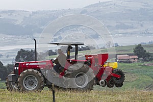 Red tractor working on field