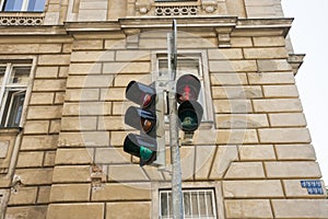 Red traffic light against building, Prague, Czech Republic