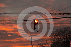 Red traffic light at the background of the evening sky