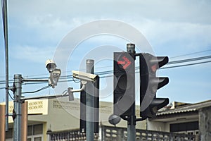 Red traffic light and CCTV Camera in the city street