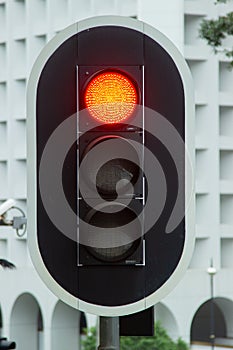 Red traffic light on city highway road close up. Traffic light on urban street.