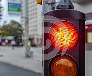 Red traffic light in the city street close