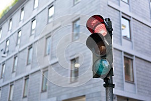 Red Traffic light in downtown with clipping path and copy space. Urban traffic or modern city life concept