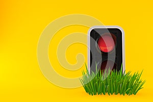 Red traffic light on grass