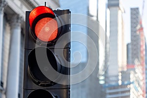 A red traffic light in a large city