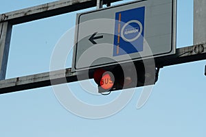 Red traffic light with letters Bus and road sign with arrow and symbol of autobus.