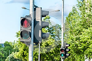 Red traffic light signal for pedestrians on the crosswalk in the city