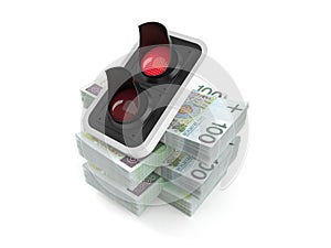 Red traffic light on stack of money