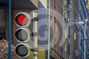 Red traffic light with timer in a blurred city background. City Street Traffic Light Showing Crossing Street Caution