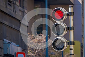 Red traffic light with timer in a blurred city background. City Street Traffic Light Showing Crossing Street Caution