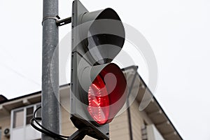 red traffic light with a timer prohibits pedestrians from crossing the road