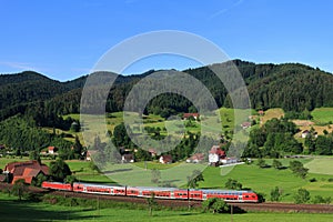 Red train in Black Forest landscape