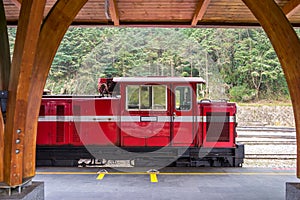 Red train on railway forest in Alishan National Scenic Area