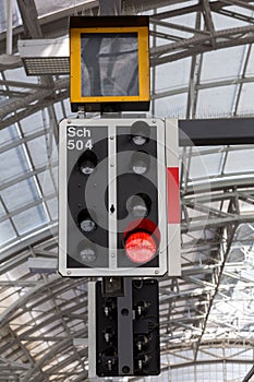 Red train signal light inside train station