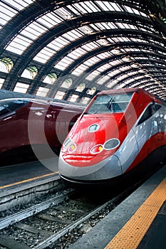 Red trains in Milan Central Station, Italy