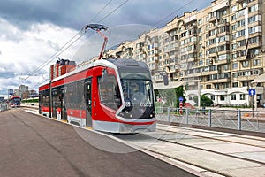 Red tram on the streets of the city