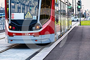 Red tram on the streets of the city