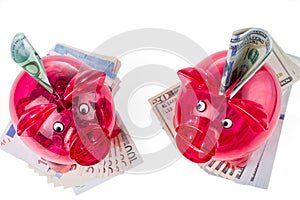 Red transparent piggy banks with dollar and euro banknotes. Diversification of investments