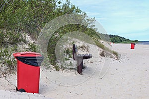 .red trash can on the beach