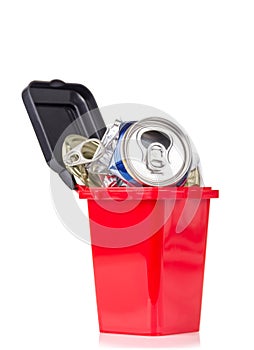 Red trash can and metal household waste isolated on white