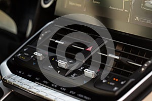 Red triangle hazard light button on car dashboard.