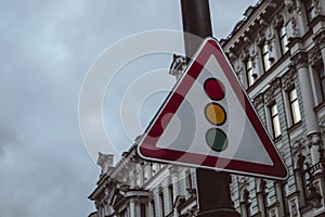 red triangle posted traffic light sign control city street safety