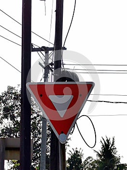 Red triangle-shaped roadmark on the side of the road