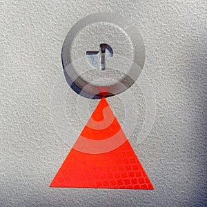 Red triangle on textured metal