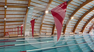 Red triangular flags above swimming pool