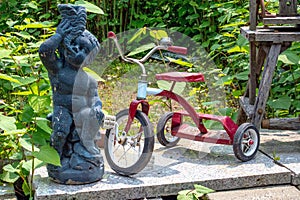 Red tricycle parked outside