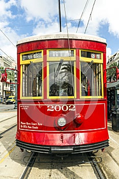 Red trolley streetcar on rail