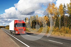Red truck on autumn highway