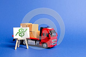 Red truck loaded with boxes and stand with a green dollar up arrow. Raise economic indicators and sales. Exports imports photo
