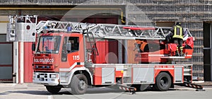 Red truck with metal scale of firefighters in the Firehouse photo
