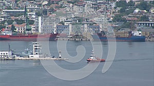 Red tug in the bay of the sea port of Varna in Bulgaria