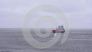 red tugboat sailing on sea water