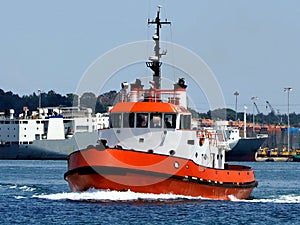 Red Tugboat Underway in Port. photo