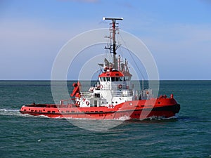 Red Tugboat Underway at Sea.